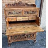 A CHINESE CARVED CAMPHORWOOD SECRETAIRE CHEST the gallery front and sides profusely carved with