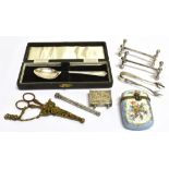 A COLLECTION OF TRINKETS TO INCLUDE SILVER A Cased silver tea spoon, a pair of silver claw sugar