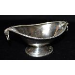 AN EDWARDIAN SILVER PEDESTAL DISH The oval dish with beaded rim border, leaf held twin ring handles,