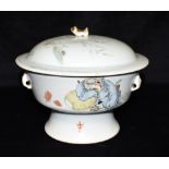 A CHINESE PORCELAIN LIDDED BOWL the lid with (rubbed) decoration of a pair of figures in a garden,