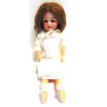 A SIMON & HALBIG BISQUE SOCKET HEAD DOLL with a brown wig, 'flirty' brown glass eyes, pierced