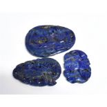 THREE LAPIS LAZULI TYPE CARVED PENDANTS the largest 6cm long Condition Report : Good condition