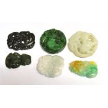 TWO CHINESE JADE TYPE CARVINGS a Maori Tiki pendant and three further carvings, largest item