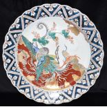 A LARGE CHINESE PORCELAIN CHARGER decorated in the Imari palette with a phoenix holding a branch,