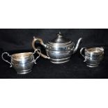 GEORGE V SILVER THREE PIECE TEA SET The teapot with ebonised knob and handle together with matched