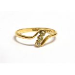 18CT GOLD DIAMOND CROSS OVER RING The ring set with three tiny diamonds, the shank hallmarked for