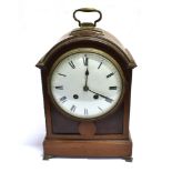 AN EDWARDIAN MAHOGANY CASED MANTLE CLOCK the slightly convex enamel dial with Roman numerals, the