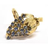 STAMPED 18K SAPPHIRE STATEMENT RING The centrally set sapphire cluster shaped as a fruit or flower