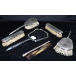 A SIX PIECE SILVER DRESSING TABLE SET comprising a mirror, a comb (a/f), two pairs of brushes,