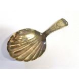 A 19TH CENTURY SILVER CADDY SPOON The spoon with bright cut pattern handle and shell bowl, lion
