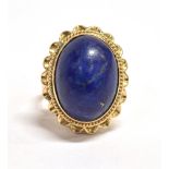 STAMPED 14K STATEMENT RING The ring set with an oval blue paste stone (Azure shade) measuring 1.6