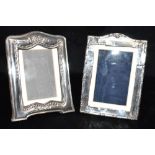 A SILVER PHOTOGRAPH FRAME together with another, both with moulded decoration, and both hallmarked