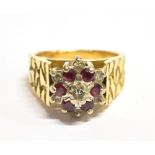DIAMOND AND GARNET CLUSTER RING The cluster, Bombe style measuring 1cm in diameter on a textured