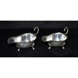 MATCHED PAIR OF SILVER SAUCE BOATS The boats with flying scroll handles, fluted rims and three