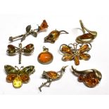 NINE ITEMS OF JEWELLERY to include pressed/faux amber, two butterfly brooches, one dragonfly brooch,