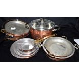 A COLLECTION OF COPPERWARE including graduated set of six copper pans with brass handles, the