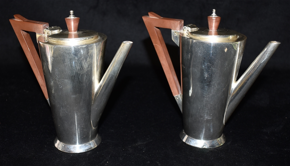 PAIR OF SILVER ART DECO COFFEE POTS An elegant pair standing 14.5cm high, with possibly Bakelite