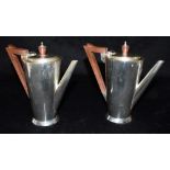 PAIR OF SILVER ART DECO COFFEE POTS An elegant pair standing 14.5cm high, with possibly Bakelite
