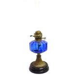 AN EDWARDIAN OIL LAMP with blue glass reservoir, 55cm high including funnel