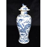 A CHINESE BALUSTER SHAPED LIDDED VASE decorated with celestial dragons, four character Kangxi mark