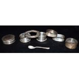 ASSORTED SILVER NAPKIN RINGS & PILL POTS Five assorted engraved and plain napkin rings, a silver
