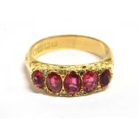 VICTORIAN FIVE STONE RING Oval cut red paste stones accentuated with senaille cut diamonds, with