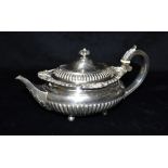 VICTORIAN SILVER TEAPOT Of oval demi gadrooned form with foliate and shell decoration to top,