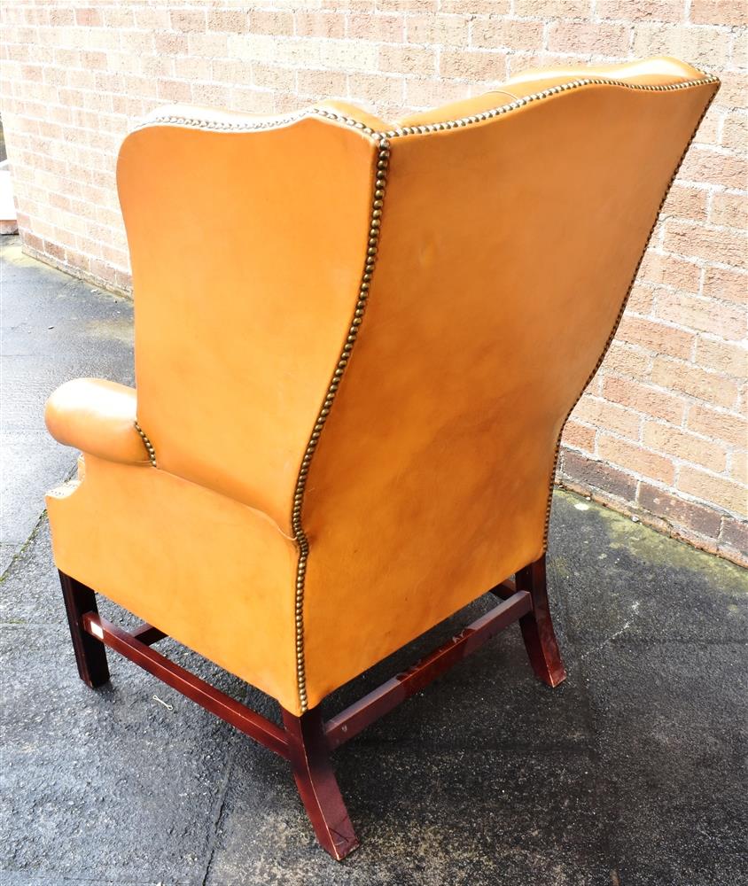 A TAN LEATHER BUTTON UPHOLSTERED WING ARMCHAIR with scroll arms, on square moulded supports, 78cm - Image 2 of 2