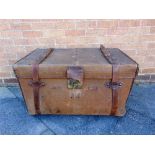 A CANVAS & LEATHER TRAVELLING TRUNK by Finnigans, Manchester, the interior with a lift-out tray,