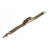 SILVER, GOLD & AMETHYST BRACELET Featuring a handmade, pierced centrepiece, surmounted by an oval