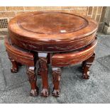 A NEST OF FIVE CHINESE HARDWOOD TABLES ON CLAW AND BALL FEET the largest 67cm diameter, the four