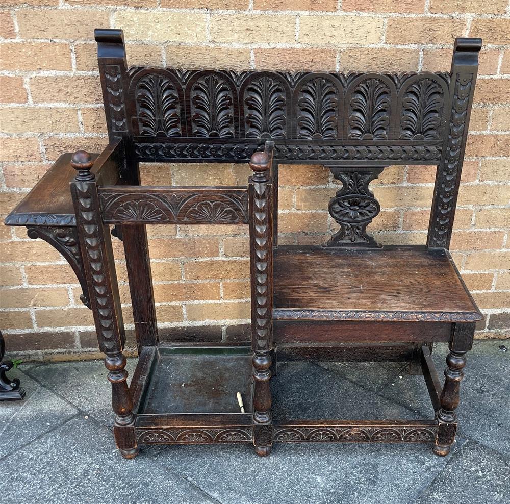 A CARVED OAK HALL BENCH/STICK STAND 105cm wide 101cm high