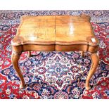 A WALNUT STOOL ON CARVED CABRIOLE SUPPORTS with pad feet, the shaped rectangular top 59cm x 40cm,