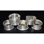ASSORTED ENGRAVED SILVER NAPKIN RINGS Five napkin rings some with fine engine turned decoration