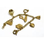 9CT GOLD CURB LINK CHARM BRACELET 18cm long with 8 gold charms, and a base metal bolt ring clasp.