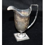 EDWARDIAN STERLING SILVER CREAM JUG Stands 14cm high of helmet form on short pedestal base, with