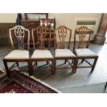 A SET OF FOUR ELM DINING CHAIRS with pierced splat backs and drop-in seats