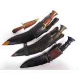 MILITARIA - A KUKRI the 26cm typically curved blade with a hardwood grip, in its leather sheath,