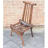 A PRIMITIVE SIDE CHAIR of open rustic design raised on four splayed supports, 89cms high.