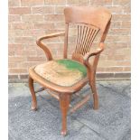 AN OAK OFFICE ARMCHAIR with pierced vase shaped splat, shepherds crook arms, green leather