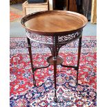 AN EDWARDIAN MAHOGANY CIRCULAR TRAY TOP OCCASIONAL TABLE with open fret carved frieze, on square