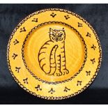 A 20TH CENTURY SLIPWARE DISH decorated to centre with a seated cat, 29cm diameter, impressed mark to