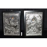 TWO REPRODUCTION ICONOGRAPHIC PLAQUES embossed white metal mounted on ebonised boards, each