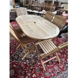 A GARDEN TABLE & 6 FOLDING CHAIRS The hardwood shaped table 160cm long & 90cm wide Condition