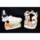 TWO STAFFORDSHIRE GROUPS one a girl standing beside a baby in crib 15cm high, the other a musical
