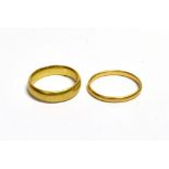 TWO 22CT GOLD WEDDING BANDS One Hallmarked Birmingham Ring size J 1/2. Weighs 5.3 grams. One