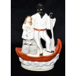 A STAFFORDSHIRE FLATBACK FIGURE of Uncle Tom and Eva in a boat, 32cm high Condition Report : good