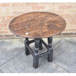 AN OAK OCCASIONAL TABLE 18th century and later, the circular top 67cm diameter 62cm high Condition