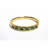 EMERALD & DIAMOND ETERNITY RING A modern 9ct gold channel set eternity, hallmarked 375. Ring size S.