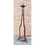 AN EDWARDIAN MAHOGANY COATSTAND raised on a circular base and three outswept supports, 204cms High